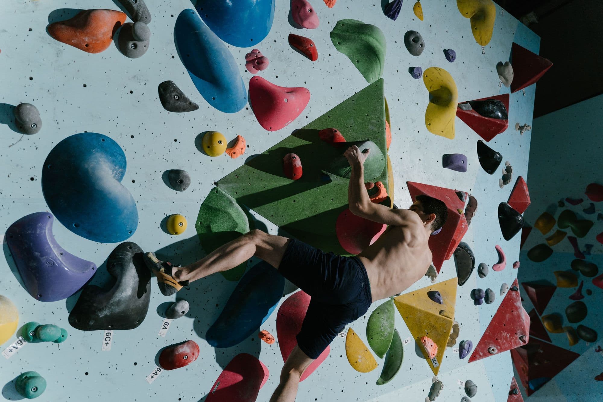 Climber training on an indoor bouldering wall