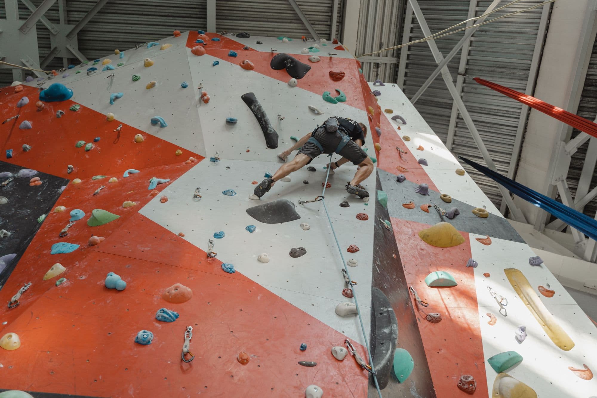 Climber on a tall indoor competition-style wall